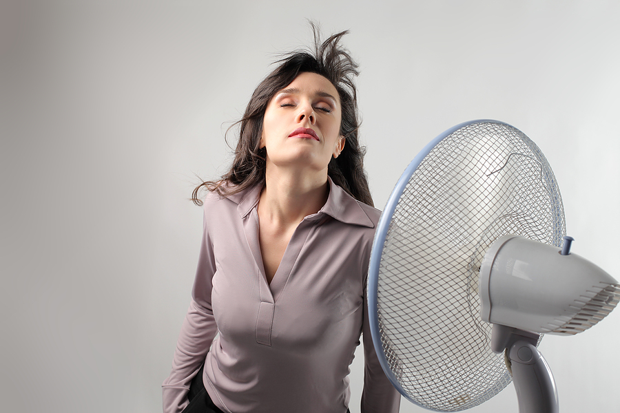 Woman standing in front of a fan